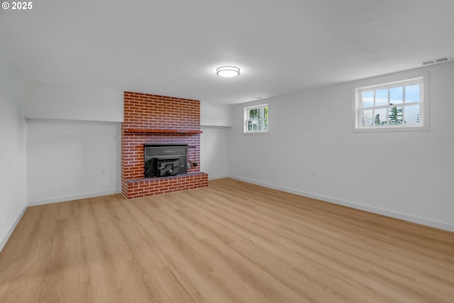 6195 Pear Tree Ln SE, Salem, OR 97317 - unfurnished living room with light wood-style flooring and a brick fireplace