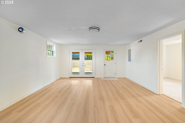 6195 Pear Tree Ln SE, Salem, OR 97317 - empty room with french doors, light wood-style flooring, healthy amount of natural light, and electric panel