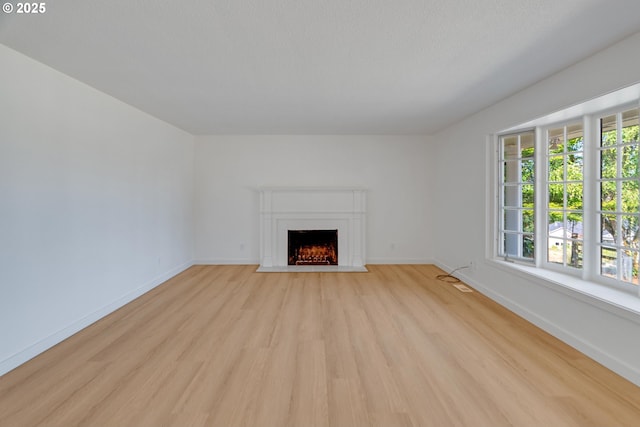 6195 Pear Tree Ln SE, Salem, OR 97317 - unfurnished living room featuring light wood-style floors and a fireplace with flush hearth