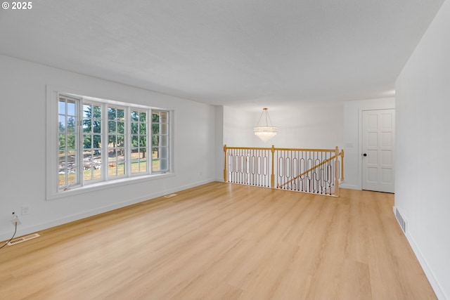 6195 Pear Tree Ln SE, Salem, OR 97317 - spare room featuring light wood-style floors and a chandelier