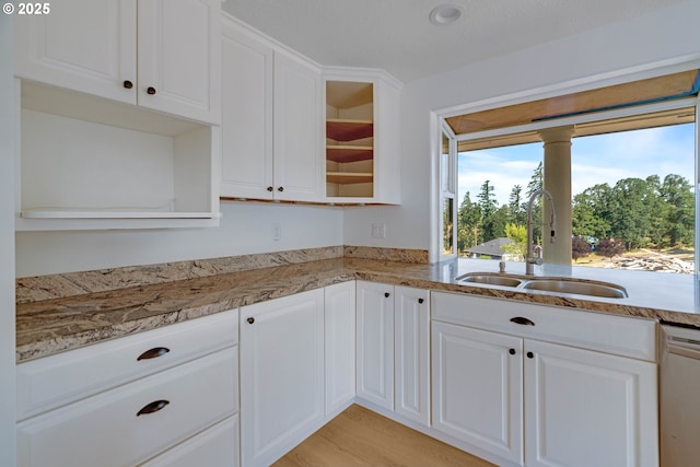 6195 Pear Tree Ln SE, Salem, OR 97317 - kitchen featuring white dishwasher, white cabinetry, glass insert cabinets, light stone countertops, and light wood finished floors