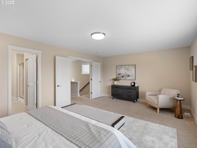 bedroom with visible vents, baseboards, and light carpet