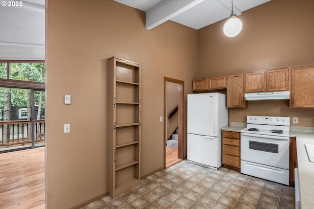 761 Foothill Dr, Eugene, OR 97405 - kitchen with white appliances, under cabinet range hood, light countertops, a high ceiling, and pendant lighting