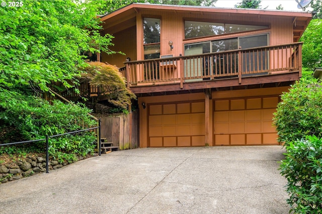 761 Foothill Dr, Eugene, OR 97405 - chalet / cabin featuring an attached garage, a balcony, and driveway
