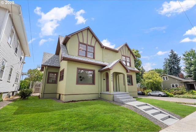 4004 N Montana Ave, Portland, OR 97227 - tudor house featuring stucco siding, a front lawn, and a shingled roof