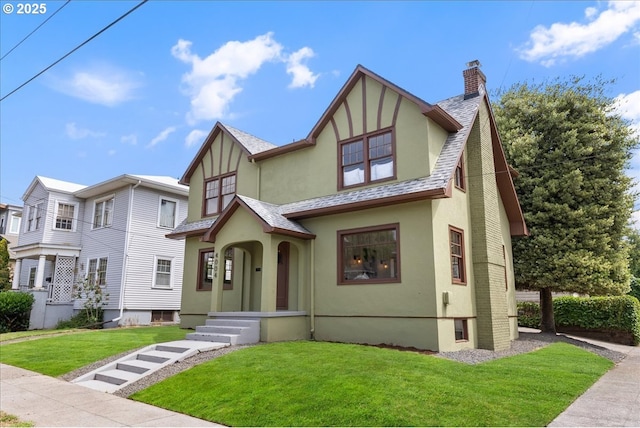 4004 N Montana Ave, Portland, OR 97227 - english style home with stucco siding, a chimney, a front lawn, and a shingled roof