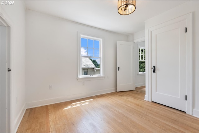 4004 N Montana Ave, Portland, OR 97227 - unfurnished bedroom with multiple windows, light wood-type flooring, and crown molding