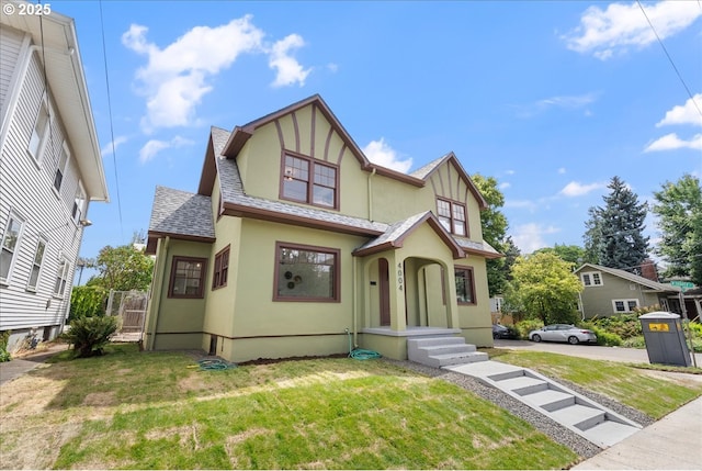 4004 N Montana Ave, Portland, OR 97227 - tudor-style house with stucco siding, a front lawn, and roof with shingles