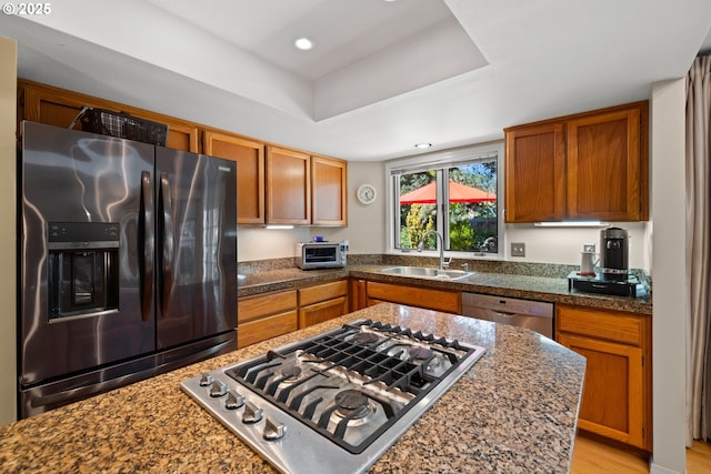 16165 NW Blueridge Dr, Beaverton, OR 97006 - kitchen with stainless steel appliances, brown cabinets, recessed lighting, a raised ceiling, and tile counters