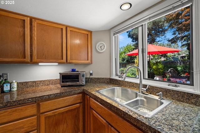 16165 NW Blueridge Dr, Beaverton, OR 97006 - kitchen with brown cabinetry and dark countertops
