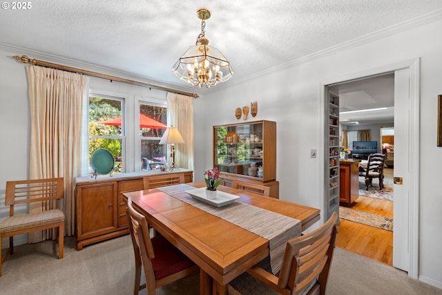 16165 NW Blueridge Dr, Beaverton, OR 97006 - dining area featuring a chandelier, a textured ceiling, light colored carpet, and ornamental molding