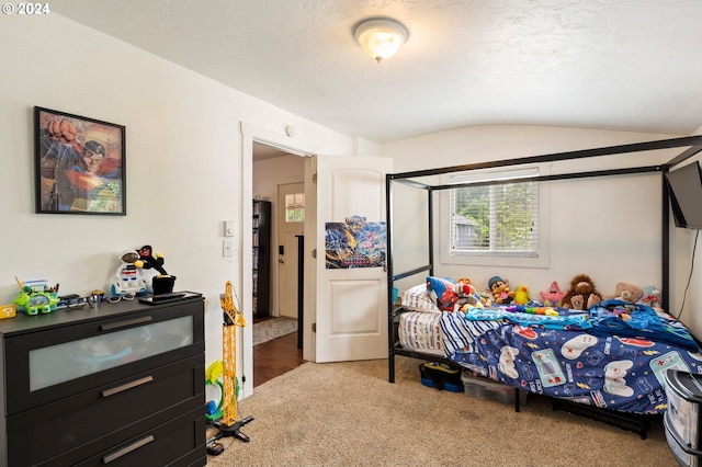 carpeted bedroom with brick ceiling and vaulted ceiling