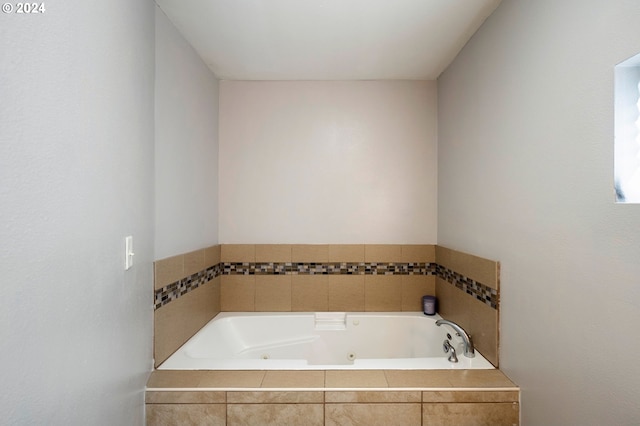 bathroom featuring tiled tub