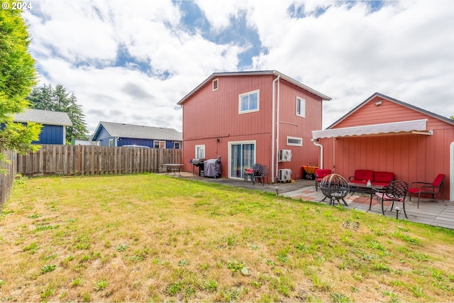 back of property with an outdoor fire pit, a patio area, and a yard