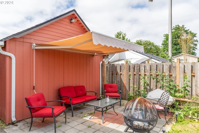 view of patio / terrace featuring an outdoor fire pit