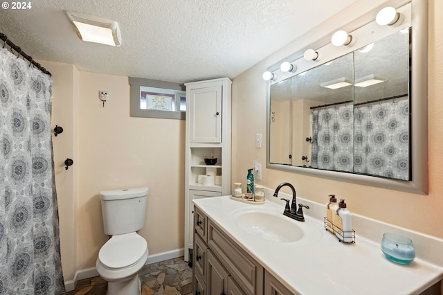 bathroom with a textured ceiling, toilet, vanity, and a shower with shower curtain