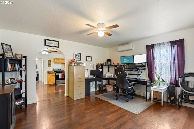 office space with ceiling fan, dark hardwood / wood-style flooring, a textured ceiling, and a wall unit AC