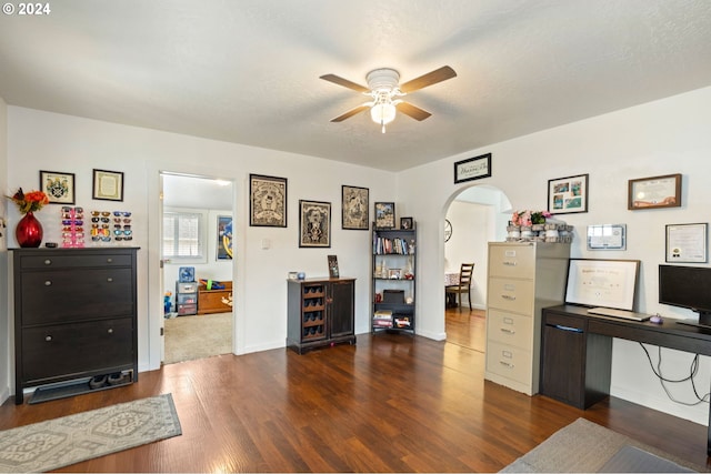 office area with ceiling fan, dark hardwood / wood-style flooring, and a textured ceiling