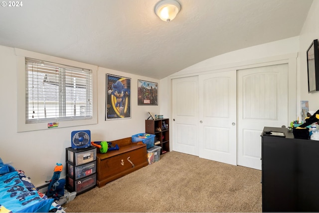 bedroom with lofted ceiling, a closet, and carpet floors