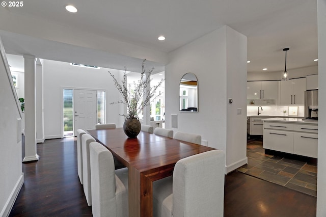 dining space with recessed lighting, baseboards, decorative columns, and dark wood-style flooring