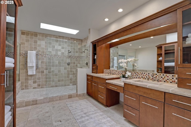 full bathroom with a walk in shower, decorative backsplash, two vanities, and recessed lighting