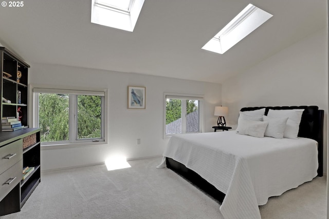 bedroom with a skylight, carpet floors, and vaulted ceiling
