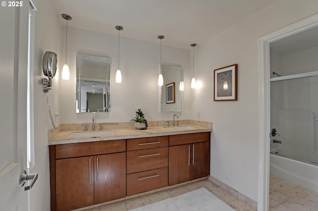full bathroom featuring double vanity, baseboards, and  shower combination