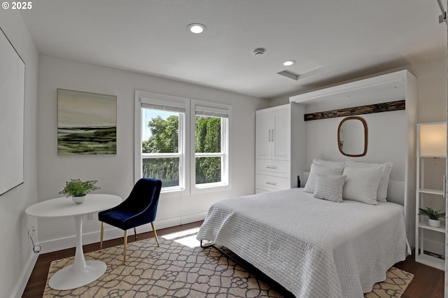 bedroom featuring wood finished floors, baseboards, and recessed lighting