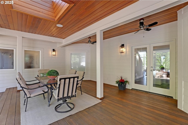 deck with french doors, a ceiling fan, and outdoor dining area