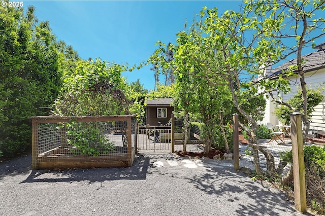 gate featuring a garden and fence
