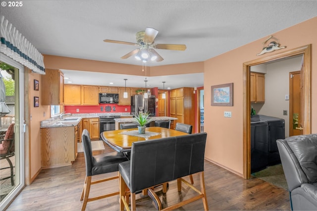 180 NE 29th Dr, Gresham, OR 97030 - dining room featuring light wood-type flooring, ceiling fan, and washer and clothes dryer