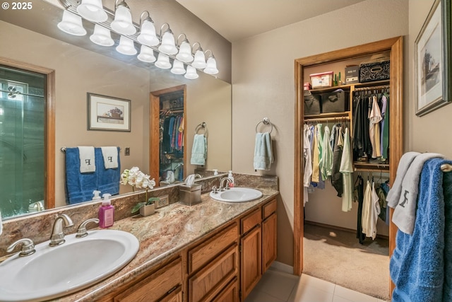 180 NE 29th Dr, Gresham, OR 97030 - bathroom featuring double vanity, a walk in closet, and tile patterned flooring
