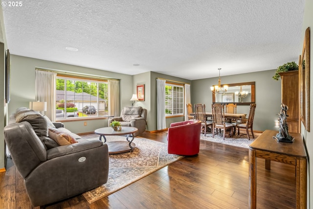 180 NE 29th Dr, Gresham, OR 97030 - living room with a chandelier, a textured ceiling, dark wood finished floors, and baseboards