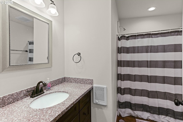 bathroom featuring curtained shower, visible vents, vanity, and recessed lighting