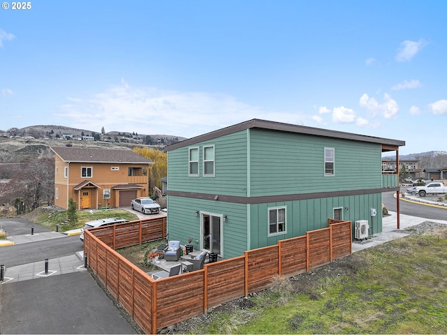 back of house featuring fence and a residential view