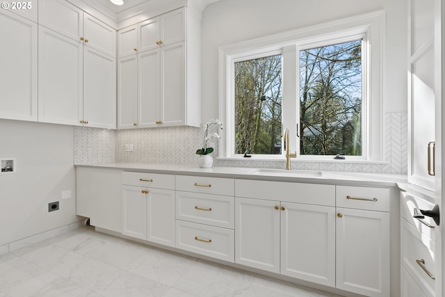 laundry area with hookup for an electric dryer, light marble finish flooring, cabinet space, hookup for a washing machine, and baseboards