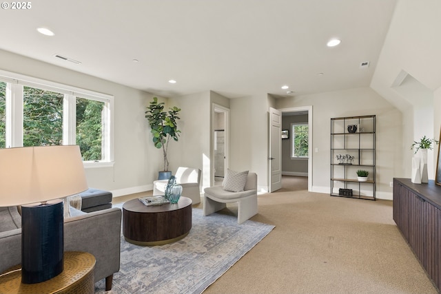 living area featuring recessed lighting, light colored carpet, and baseboards