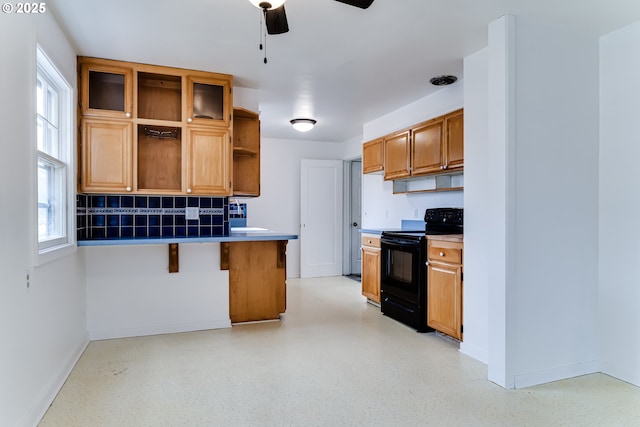 kitchen featuring baseboards, a breakfast bar, open shelves, ceiling fan, and black electric range oven