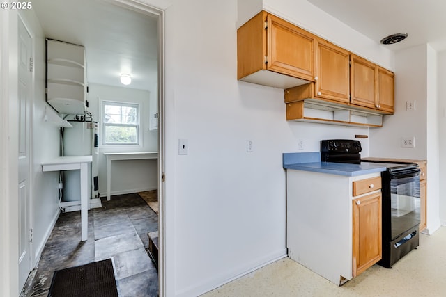 kitchen featuring black range with electric stovetop, baseboards, and electric water heater