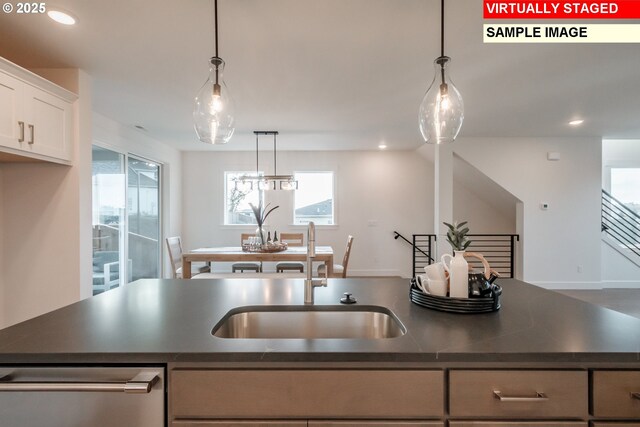 22987 Bland Cir, West Linn, OR 97068 - kitchen with a sink, dark countertops, stainless steel dishwasher, recessed lighting, and white cabinets
