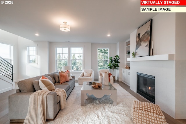 22987 Bland Cir, West Linn, OR 97068 - living room featuring a glass covered fireplace, recessed lighting, light wood-style floors, and baseboards