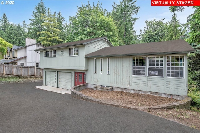 162 Monticello Dr, Longview, WA 98632 - tri-level home featuring asphalt driveway and a garage