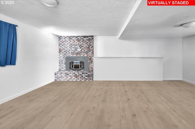162 Monticello Dr, Longview, WA 98632 - unfurnished living room featuring a textured ceiling, wood finished floors, and a wood stove