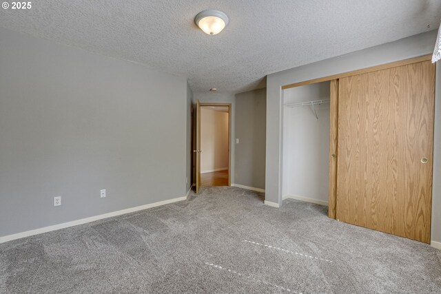 3057 Raymond St, Forest Grove, OR 97116 - unfurnished bedroom featuring carpet flooring, a closet, a textured ceiling, and baseboards