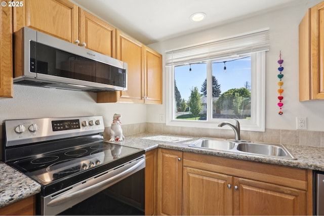 kitchen featuring appliances with stainless steel finishes and a sink