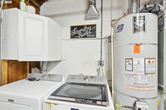 clothes washing area with water heater, cabinet space, and washer and clothes dryer