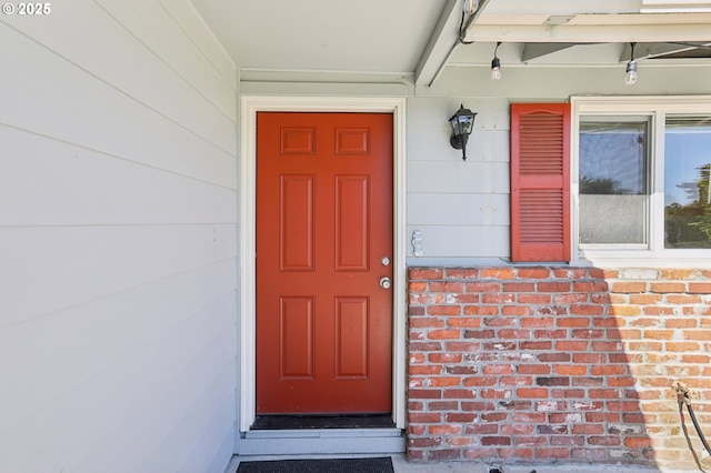 entrance to property with brick siding