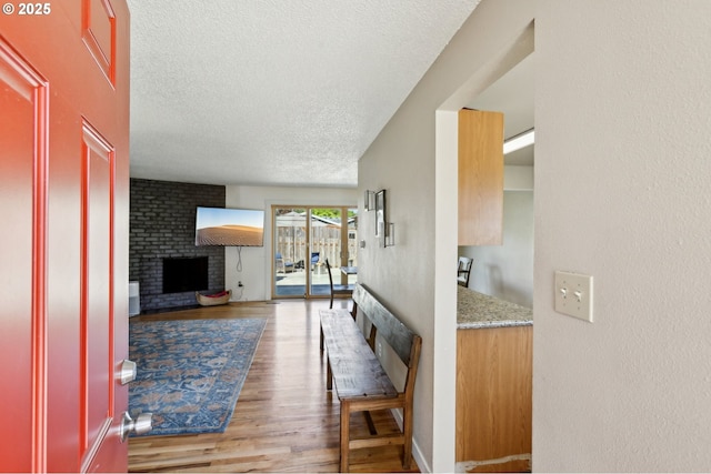 hallway featuring a textured ceiling and wood finished floors
