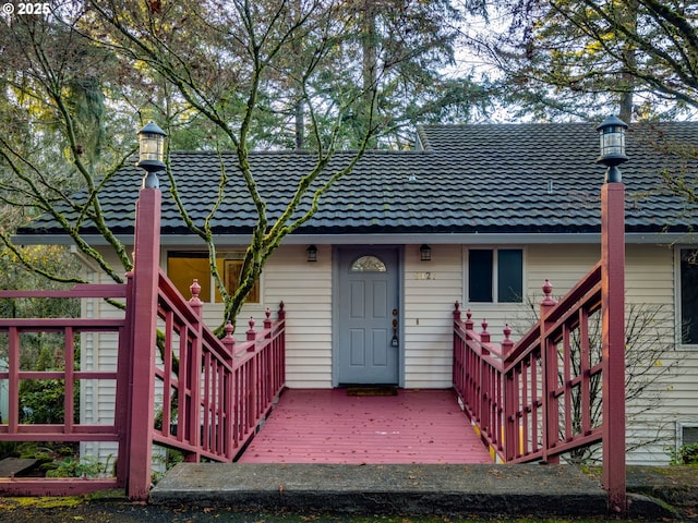 back of property with a wooden deck