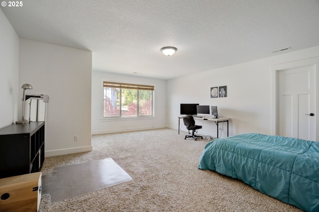 carpeted bedroom with visible vents, baseboards, and a textured ceiling